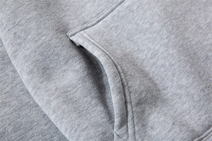 Close-up of grey marl knit fabric and durable double-stitch seam detail on the hoodie