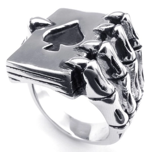 Retro skeleton hand ring holding a spade poker card in vintage silver metal