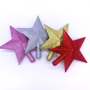 Detail of glittered star tree toppers in pink, silver, gold, and red with cone bases