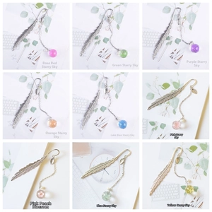 Detailed grid view of metal feather bookmarks featuring various dried flower glass pendants