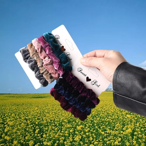 Close-up of velvet scrunchies set in various colors displayed on a Sweet Girl card