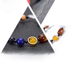 Detailed close-up of natural stone solar system bracelet beads with cosmic galaxy theme