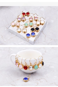 Detail of colorful round crystal earrings with gold French hooks on elegant gift packaging