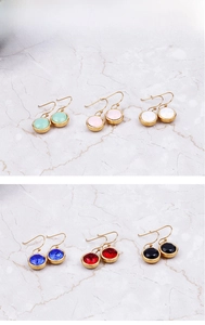 Detail view of round zircon earrings in six colors with gold-plated stainless steel hooks