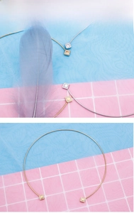 Detail of minimalist stainless steel choker featuring square micro-pave zircon pendants