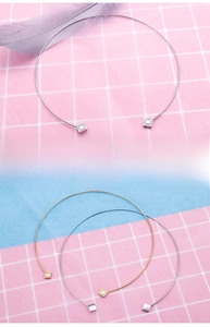 Detail view of adjustable stainless steel chokers with square diamond accents