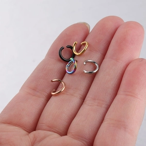 Handheld view of multi-color stainless steel jump rings in black, gold, and silver