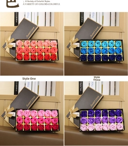 Close-up of 18 soap rose gift boxes in red, blue, pink, and purple colors with golden ribbons