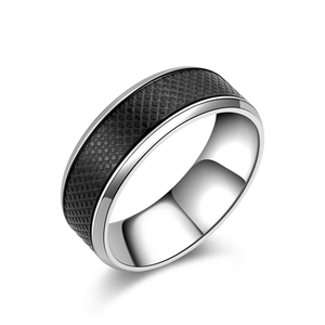 Detail view of vintage stainless steel ring with black checkered pattern and silver edges