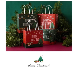 Detailed view of red and green Christmas gift bags with rivet handles and festive patterns