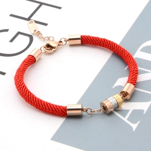 Three-tone cylinder pendants on red woven rope bracelet with adjustable clasp