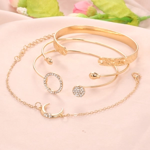 Golden 4-piece bracelet set with moon pendant, open cuff, and sparkling zircon crystals