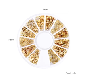 Detailed set of golden moon and star nail art studs in a 12-slot circular container