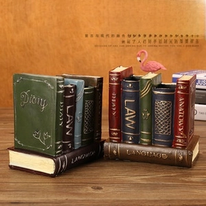 Detailed view of vintage book-style resin pen holders with antique finish and golden text