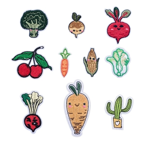 Detail of multi-colored vegetable and plant embroidered iron-on patches on white background