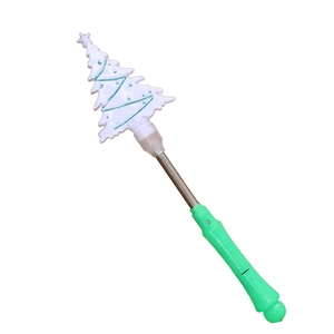 Detail of Christmas tree glowing wand with green handle and spring mechanism