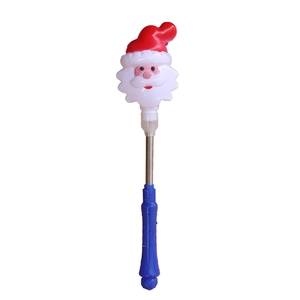 Detail view of a glowing Christmas spring wand with Santa Claus design and blue handle