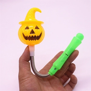 Close-up of Halloween glowing pumpkin wand with spring neck and green handle