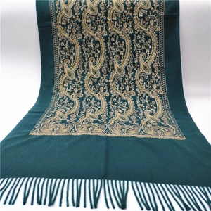 Detail of green paisley embroidery on thick cashmere-like scarf with fringe tassels