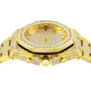 Macro side view of gold iced-out octagonal watch showing diamond setting and thickness