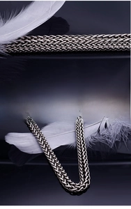 Detailed close-up of heavy braided titanium steel chain with dark silver finish