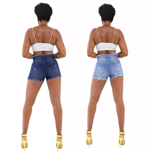 Women's ripped denim shorts in light and dark blue wash with frayed hem and lift design
