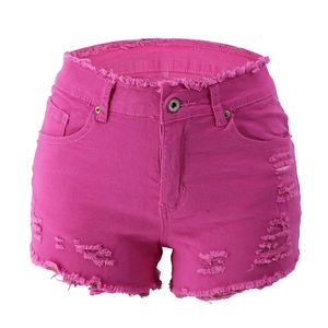 Close-up of rose pink ripped denim shorts with frayed edges and distressed details