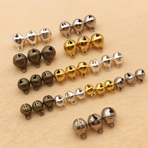 Assorted metallic bell pendants in silver, gold, and bronze for DIY jewelry making