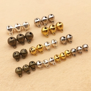 Macro detail of assorted vintage metal bells in gold, silver and bronze for DIY crafts