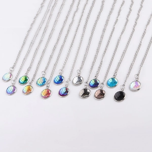 Close-up of 12mm stainless steel necklaces featuring multi-colored fish scale pendants