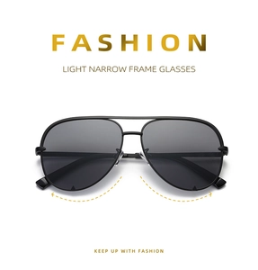 Detail of light narrow frame aviator sunglasses with classic double bridge design