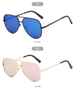 Close-up of classic aviator sunglasses showing black frames and gold frames with gradient lenses