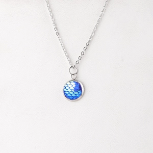Detail of 12mm silver stainless steel necklace with blue and purple fish scale pendant