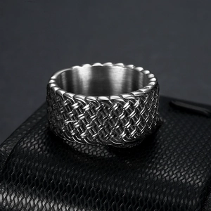 Macro view of vintage stainless steel ring with detailed V-shaped woven texture
