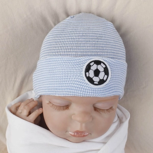 Close-up of baby knit hat featuring blue stripes and a soccer ball embroidery patch
