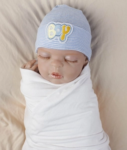 Detail of blue and white striped baby beanie with BOY embroidery on soft knit fabric