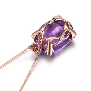 Close-up of heart clasp and large purple crystal pendant in rose gold finish