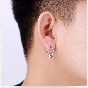 Minimalist stainless steel hoop earring with a sliding bead shown on a male model