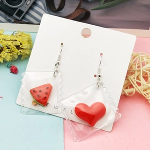 DIY handmade resin earrings featuring watermelon and heart pendants in creative mini bags