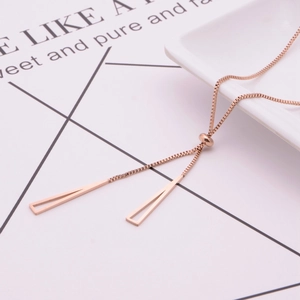 Detail of rose gold box chain necklace with hollow triangle pendants and slider buckle