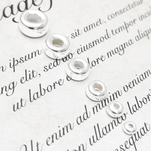Macro shot of 925 sterling silver spacer beads in various sizes for DIY jewelry