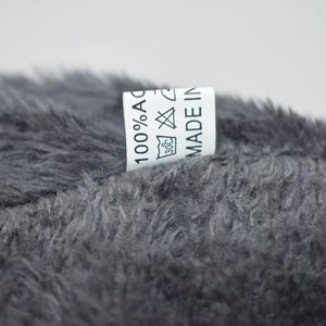 Detail of soft gray chenille knit hat showing the 100% acrylic material tag and soft inner fleece