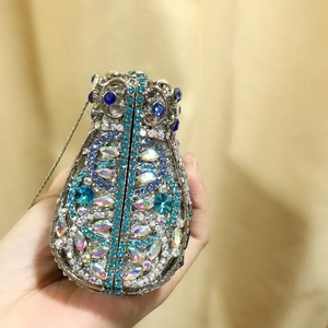 Macro detail of cat-shaped evening bag with sea blue rhinestones and silver chain strap