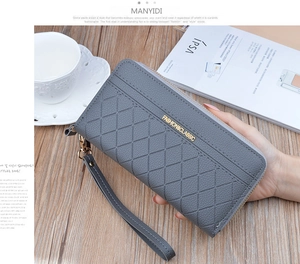 Detailed view of grey quilted leather wallet with gold zipper and card slots