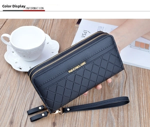 Detail of black plaid long wallet with double gold zippers and hand strap held by a model