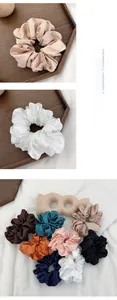 Detail of silk satin scrunchies set in multiple colors with elegant pearlescent finish
