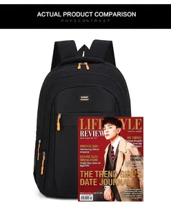 Detailed size comparison of black sports backpack with a magazine for scale