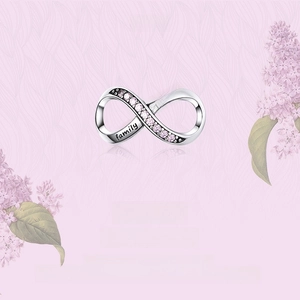 Detail of S925 silver infinity charm with pink zirconia and family forever engraving