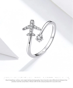 Detail view of the S925 silver stamp and sparkling cubic zirconia stones on airplane ring