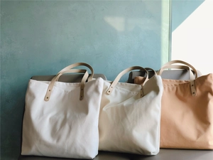 Three-color minimalist canvas tote bags with PU leather handles and metal rivets detail